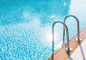 This image shows a pool with a newly resurfaced deck.