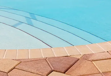 This image shows a pool with a newly resurfaced deck.