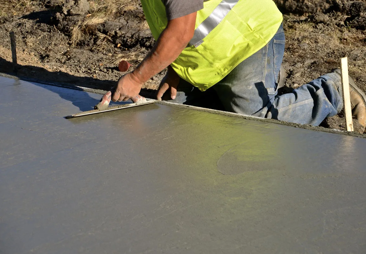 This image shows a man resurfacing a cement floor.