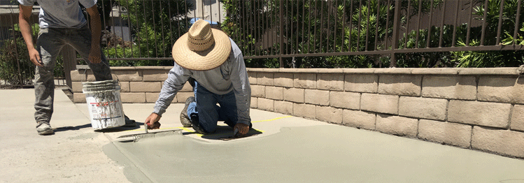 This image shows a man resurfacing a cement floor.