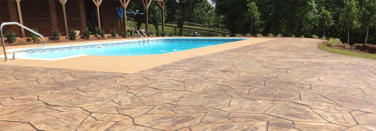 1 stampede This image shows a Stamped Concrete pool deck.