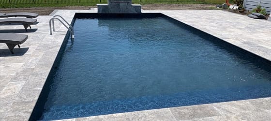 This image shows a pool with a newly resurfaced deck.