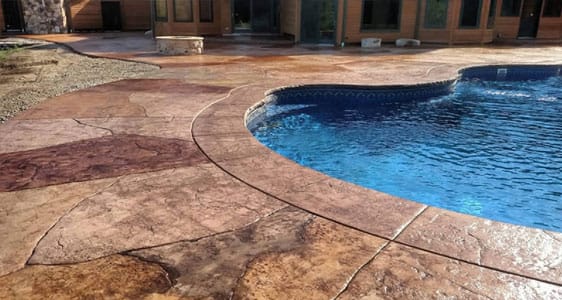 This image shows a pool with a newly resurfaced deck.