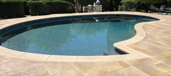This image shows a pool with a newly resurfaced deck.