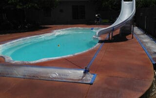 This image shows a pool with a newly resurfaced deck.