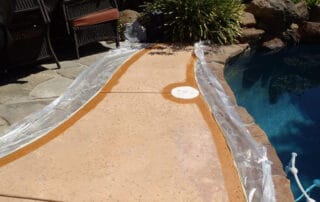 This image shows a pool with a newly resurfaced deck.