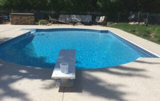 This image shows a pool with a newly resurfaced deck.
