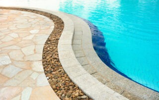 This image shows a pool deck with concrete overlay design.