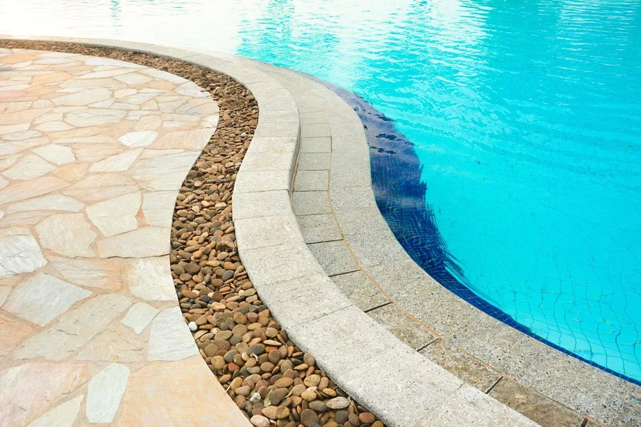 This image shows a pool deck with concrete overlay design.